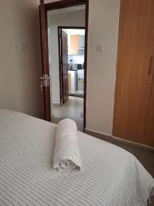 a white bed with a towel on top of it at Serene 63 Luxe in Murangʼa