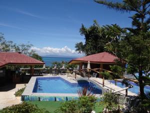 a pool at a resort with a view of the ocean at Villa Marquez in Camotes Islands