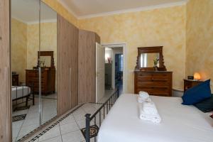 a bedroom with a large bed and a mirror at Green Square Apartment 14 Min from Santa Croce with Hydromassage Tub in Florence +23 photos