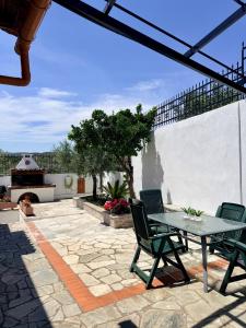a patio with a table and chairs on a patio at Blue Horizon Balcony in Volos