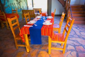 a blue table with plates and glasses on it at Tembo Tarangire Lodge & Camp in Madege +19 photos