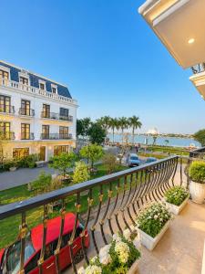 a balcony with a view of a building and the ocean at Fame Apartment in Dong Hoi +19 photos