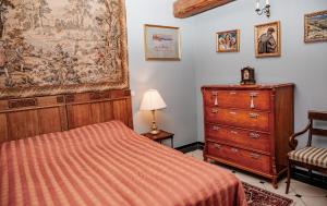 a bedroom with a bed and a dresser at Piena māja in Kukšas
