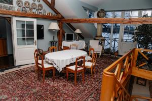 a dining room with a table and chairs at Piena māja in Kukšas