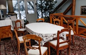 a dining room with a table and chairs and a table and chairsktop at Piena māja in Kukšas