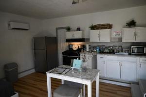 a kitchen with a table with a laptop on it at The Cottage in Dagsboro