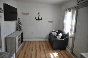 a living room with a couch and a anchor on the wall at The Cottage in Dagsboro