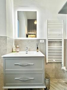 a bathroom with a sink and a mirror at Casa Ferro in Finale Ligure +5 photos
