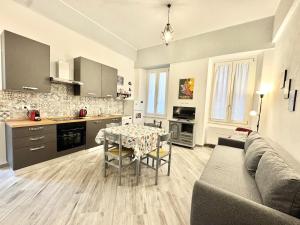 a kitchen and a living room with a couch and a table at Casa Ferro in Finale Ligure