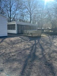 a white building with a fence in front of it at Stege Camping in Stege