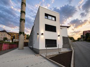 a white building with two towers on a street at Microbyty & Apartments in Děčín