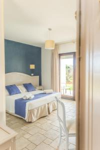 a bedroom with a bed and a chair and a window at B&B La Vigna in Carovigno +32 photos