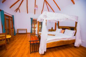 a bedroom with a bed with a canopy at Tembo Tarangire Lodge & Camp in Madege
