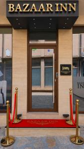 a building with a red carpet in front of a door at Bazaar Inn Boutique & Luxury Rooms in Skopje