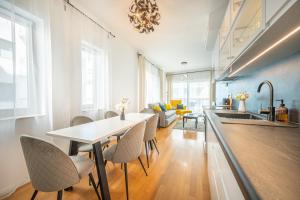 a kitchen and living room with a table and chairs at Amada Apartment in Budapest +5 photos