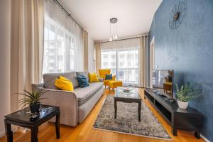 a living room with a couch and a table at Amada Apartment in Budapest