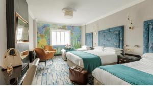 a hotel room with four beds and a window at Ashdown Park Hotel in Gorey