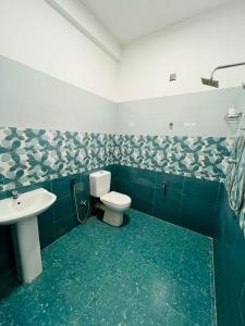 a bathroom with a toilet and a sink at Amantha Holiday Resort in Anuradhapura +22 photos