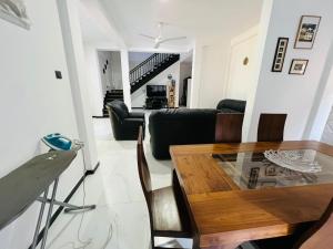 a living room with a table and a couch at Amantha Holiday Resort in Anuradhapura