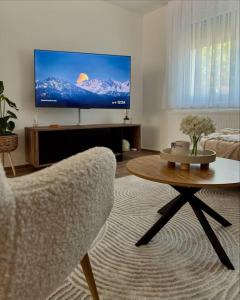 a living room with a tv and a chair and a table at Kuća za odmor Terra Marta in Đakovo