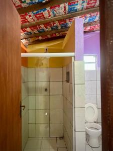 a small bathroom with a toilet and a shower at Jahospedaria & Ecoturismo in Lençóis +27 photos