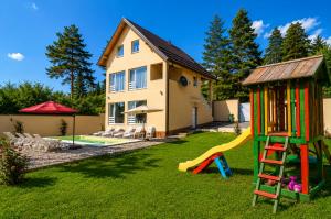 a yard with a house and a playground at Planinska Oaza in Pale