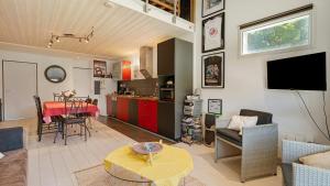 a living room with a kitchen and a dining room at Gîte Le Relais De Jehan in Saint-Malo des 3 Fontaines