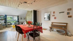 a dining room with a table and a piano at Gîte Le Relais De Jehan in Saint-Malo des 3 Fontaines