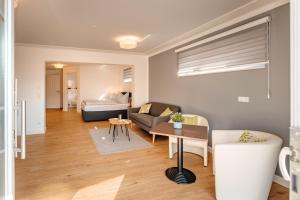 a living room with a couch and a bed at Ferienwohnung Riethchaussee in Wingerode +7 photos