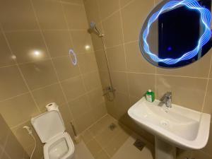 a bathroom with a toilet and a sink and a mirror at Chalet 103 - Zresidence - Faitroun in Al ‘Aqabah +8 photos