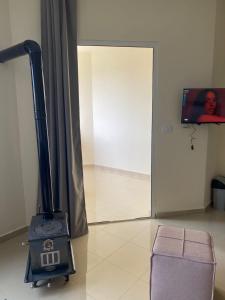 a wood stove in a room with a door at Chalet 103 - Zresidence - Faitroun in Al ‘Aqabah