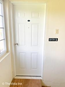 a white door in the corner of a room at The Vista Inn Studio #2 in Falmouth