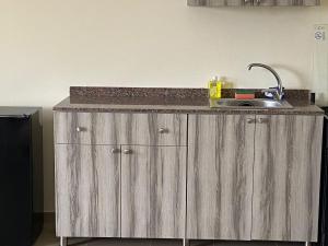 a kitchen with a counter top with a sink at Chalet 103 - Zresidence - Faitroun in Al ‘Aqabah