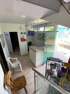 a room with a glass table and a chair at Hotel Nella Mar in Puerto Colombia