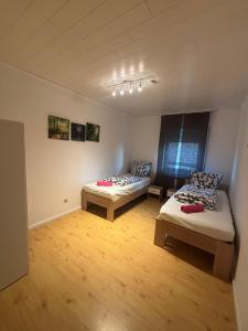 a room with two beds and a couch in it at Ferienwohnung Habichtweg in Elsdorf