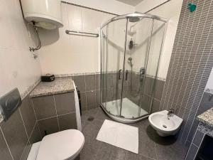 a bathroom with a shower and a toilet and a sink at Maver apartment in Mali Lošinj