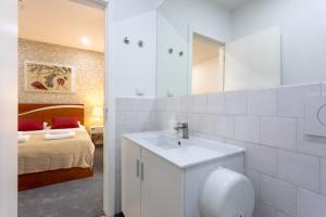 a white bathroom with a sink and a bed at Lisbon Poets Inn in Lisbon +78 photos