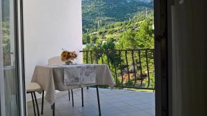 a table and chairs with a view of a mountain at Apartment & Rooms Marigold in Baška Voda