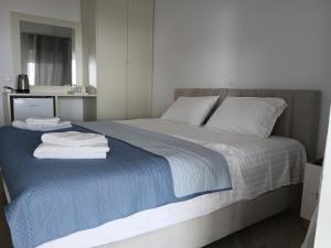 a bedroom with a bed with towels on it at Joanna hause in Gjilek +18 photos