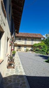 an empty street with a building and a bench at La Vita è Bella in Somano