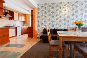 a kitchen and living room with a table and a couch at Waldi in Grzybowo