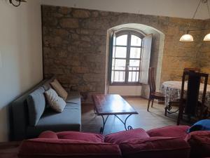 a living room with a couch and a table at El Rincon de Belen in Noriega +40 photos