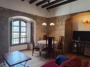 a living room with a table and a dining room at El Rincon de Belen in Noriega