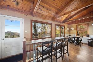 a kitchen and dining room with a bar with chairs at Blowing Rock Skies in Lenoir
