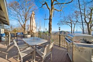 a patio with a table and a grill and an umbrella at Blowing Rock Skies in Lenoir