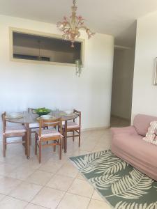 a living room with a table and chairs and a couch at Casa Kate in Scanzano +17 photos