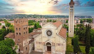 an old building with a tower and a church at VeronaVera Porta Palio Panoramic Loft in Verona