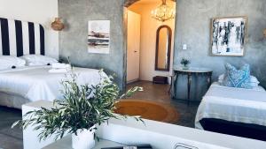 a living room with two beds and a bathtub at Duneberry Beach Studio in Yzerfontein +16 photos