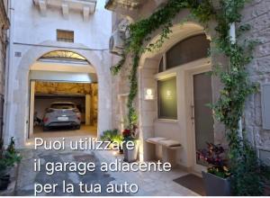a building with a car parked in a parking lot at GB Grotta Bianca in Ostuni