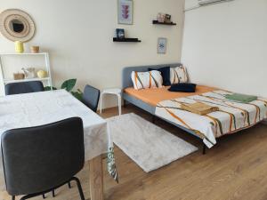 a bedroom with a bed and a table and chairs at Grand and Prime Central Apartments Varna in Varna City